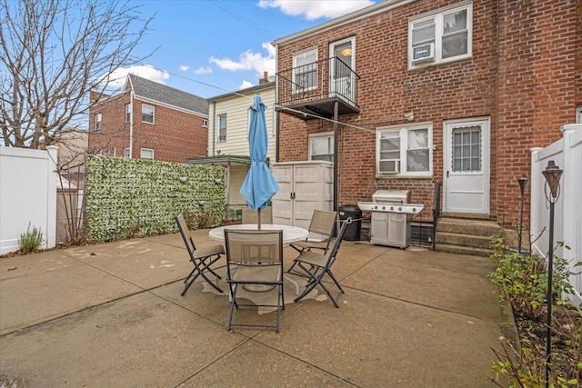 view of patio / terrace with grilling area and a balcony