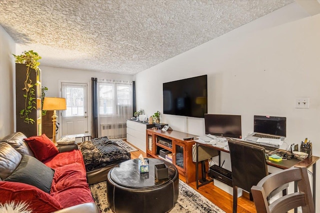 living room featuring hardwood / wood-style floors, radiator heating unit, a textured ceiling, and vaulted ceiling