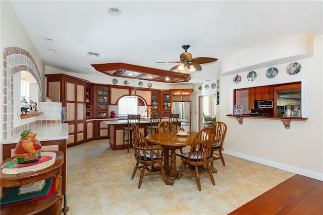 tiled dining space featuring ceiling fan