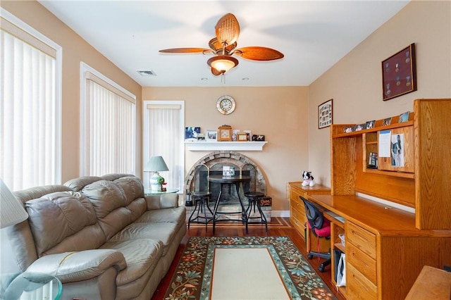 living room featuring hardwood / wood-style floors and ceiling fan