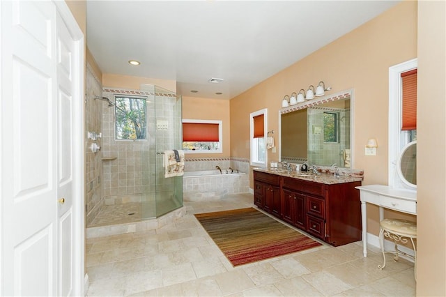 bathroom with tile patterned flooring, vanity, and shower with separate bathtub