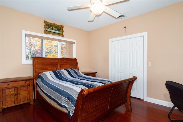 bedroom with ceiling fan, a closet, and dark hardwood / wood-style floors