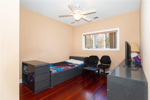 bedroom with ceiling fan and dark hardwood / wood-style floors