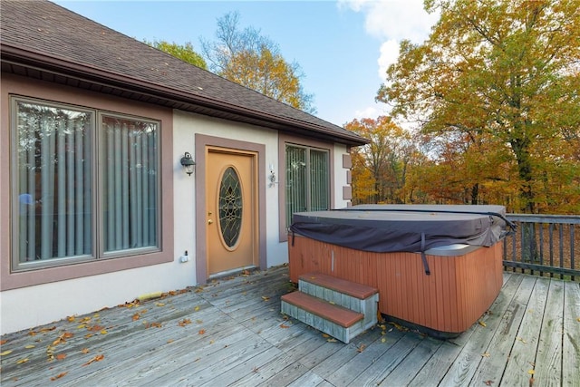 wooden deck featuring a hot tub