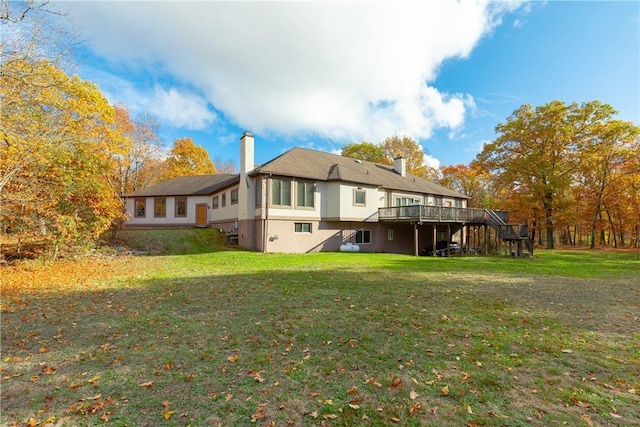 rear view of house featuring a deck and a yard