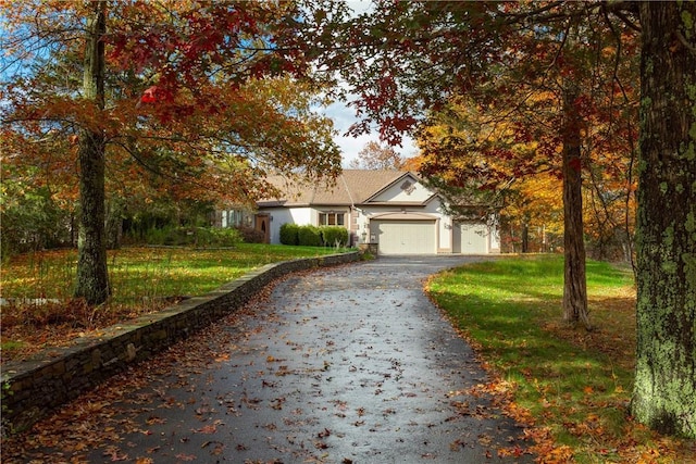 view of front of home featuring a garage and a front lawn