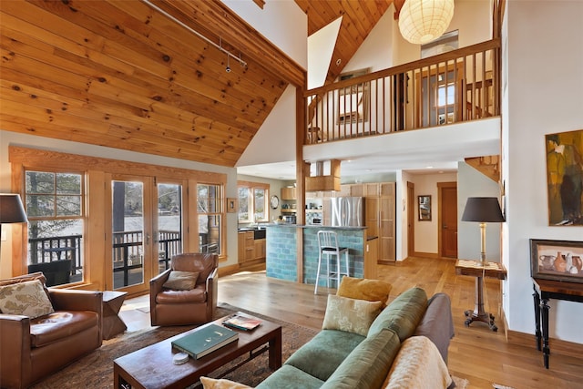 living area with high vaulted ceiling, wooden ceiling, baseboards, french doors, and light wood-type flooring