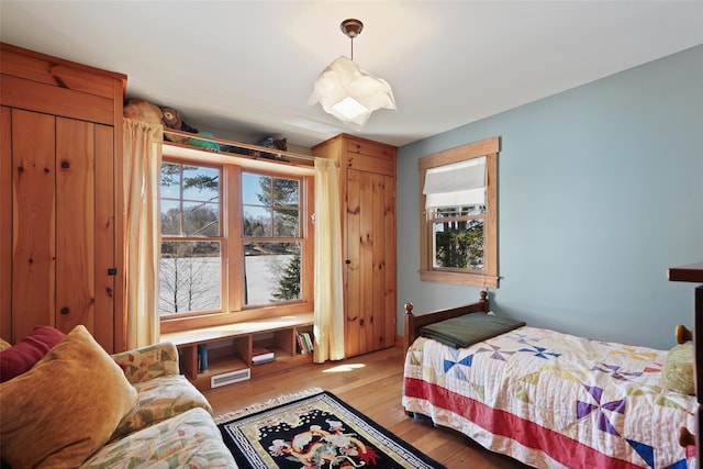 bedroom with light wood-type flooring and visible vents