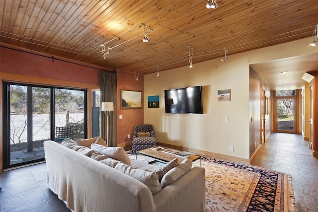 tiled living room featuring rail lighting, wood ceiling, and baseboards