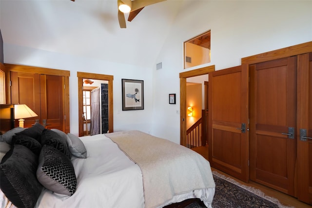 bedroom with ceiling fan, high vaulted ceiling, and visible vents