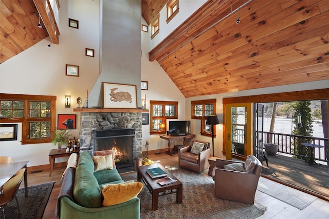 living area with wooden ceiling, a fireplace, wood finished floors, baseboards, and beamed ceiling