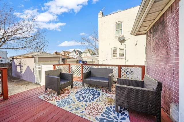 wooden deck featuring an outbuilding and an outdoor hangout area