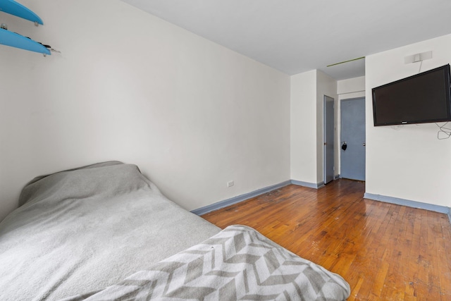 unfurnished bedroom with dark wood-type flooring