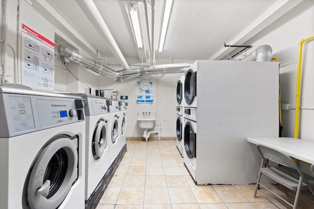 clothes washing area featuring independent washer and dryer, light tile patterned floors, and stacked washer / dryer