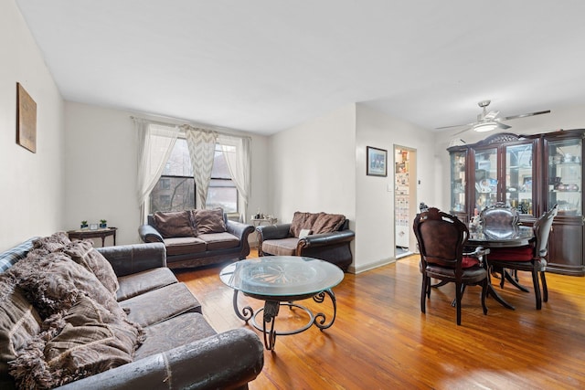 living room featuring ceiling fan and wood-type flooring