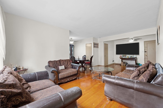 living room featuring hardwood / wood-style flooring and ceiling fan