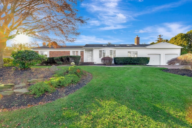 ranch-style home with a front yard and a garage