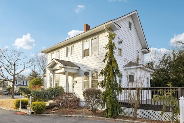 view of front facade with a wooden deck