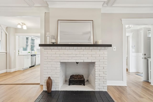 details with hardwood / wood-style flooring, dishwasher, crown molding, and a brick fireplace