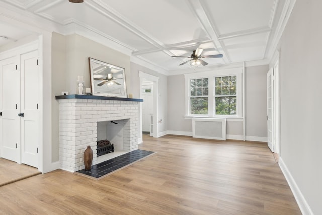 unfurnished living room with radiator heating unit, hardwood / wood-style flooring, and a brick fireplace