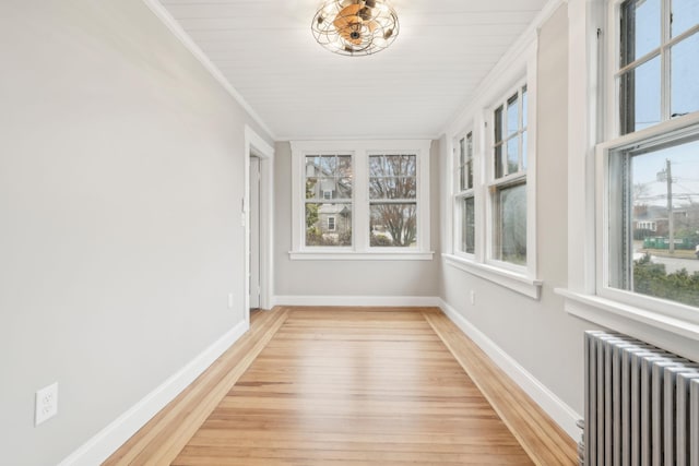 unfurnished sunroom featuring radiator