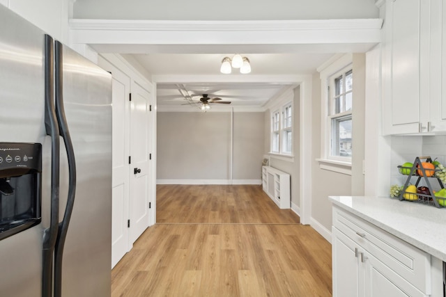 kitchen featuring white cabinetry, ceiling fan, tasteful backsplash, stainless steel fridge, and light hardwood / wood-style floors