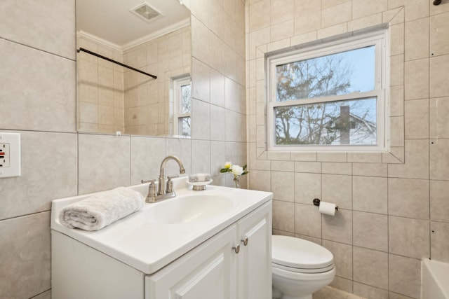 full bathroom featuring shower / bathtub combination, vanity, crown molding, tile walls, and toilet