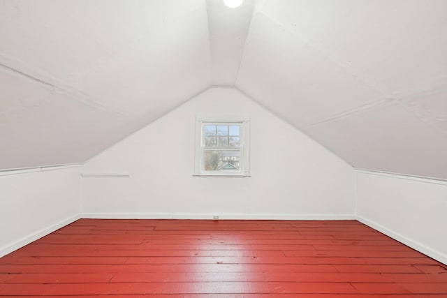 bonus room with wood-type flooring and vaulted ceiling