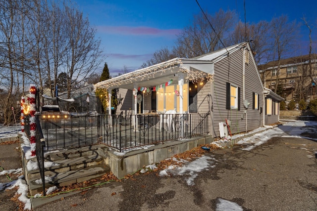 view of snowy exterior featuring a porch