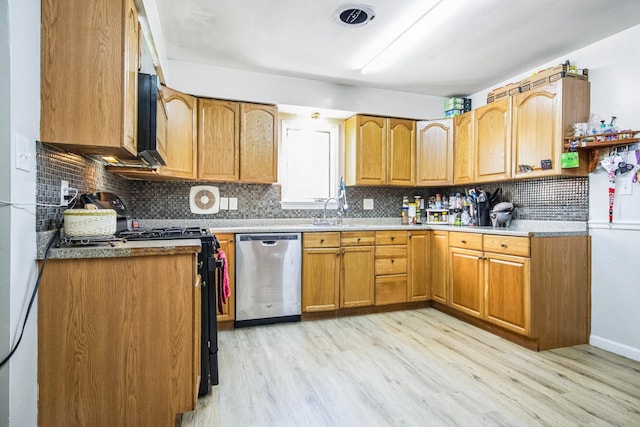 kitchen with tasteful backsplash, stainless steel dishwasher, sink, black range, and light hardwood / wood-style floors