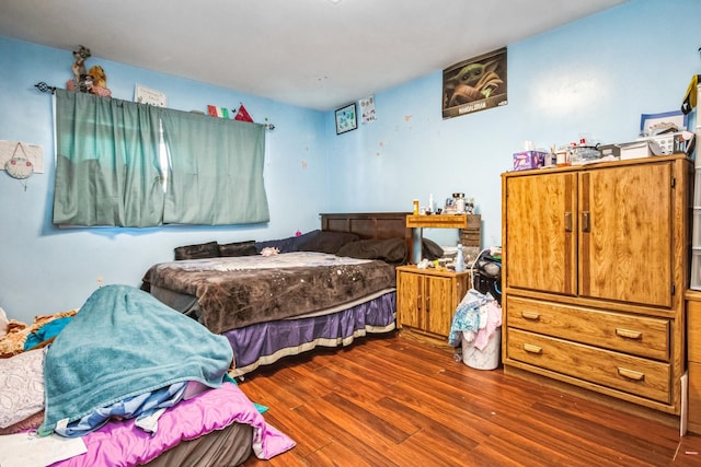 bedroom with hardwood / wood-style floors