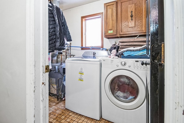 washroom featuring cabinets and washer and dryer