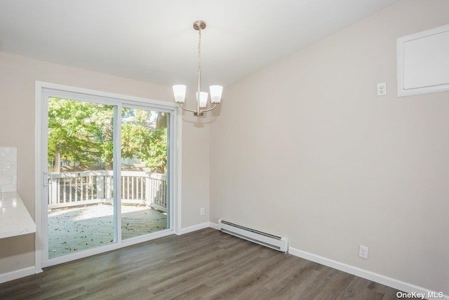 unfurnished dining area featuring an inviting chandelier, baseboard heating, and dark wood-type flooring