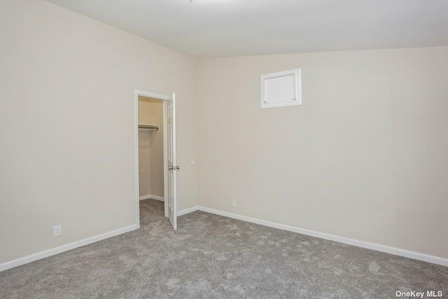 unfurnished room with light carpet and lofted ceiling