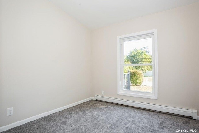 carpeted empty room featuring lofted ceiling and a baseboard heating unit