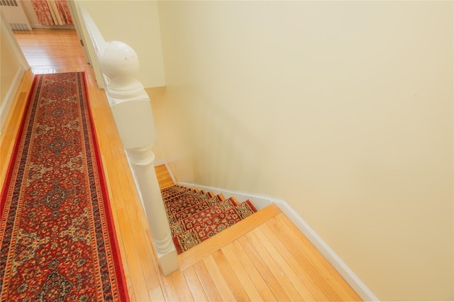 stairway featuring hardwood / wood-style flooring and radiator