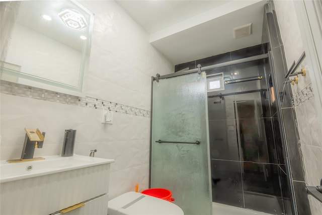 bathroom featuring vanity, toilet, and an enclosed shower