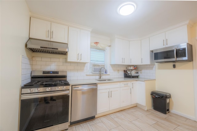 kitchen with white cabinets, decorative backsplash, sink, and appliances with stainless steel finishes