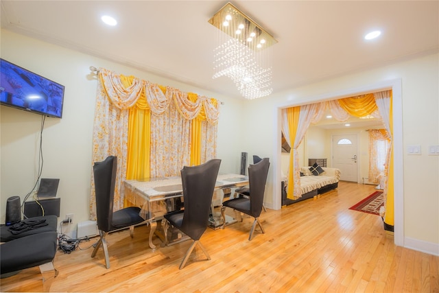 dining space featuring hardwood / wood-style flooring and a notable chandelier