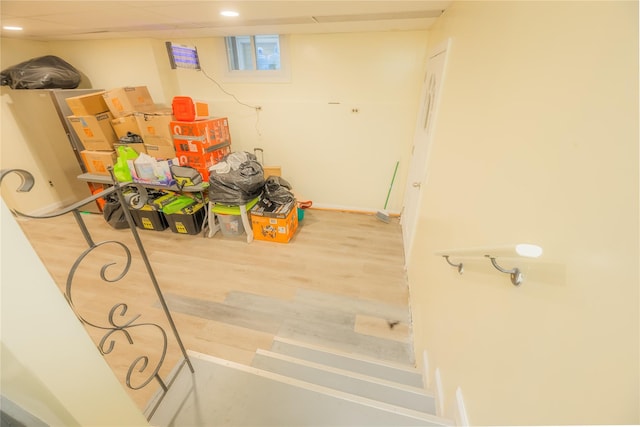 basement with hardwood / wood-style floors