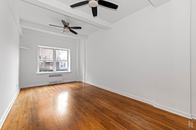 unfurnished room featuring beam ceiling, hardwood / wood-style flooring, radiator, and ceiling fan