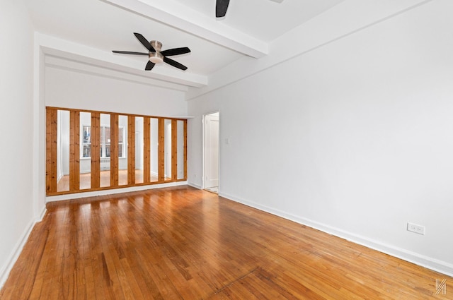 unfurnished room featuring beam ceiling, ceiling fan, and wood-type flooring