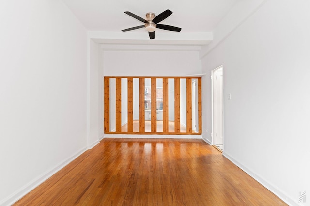 empty room featuring ceiling fan and light wood-type flooring