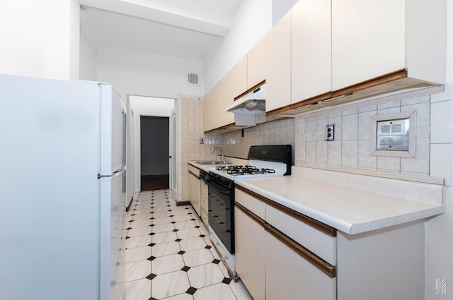 kitchen featuring backsplash, sink, white cabinets, and white appliances