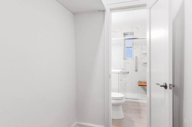 bathroom with toilet and a shower with door