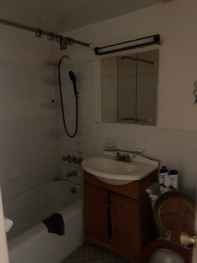 full bathroom with vanity, toilet, and tiled shower / bath combo