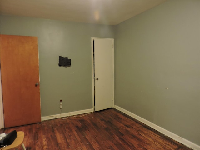 unfurnished room with dark hardwood / wood-style floors