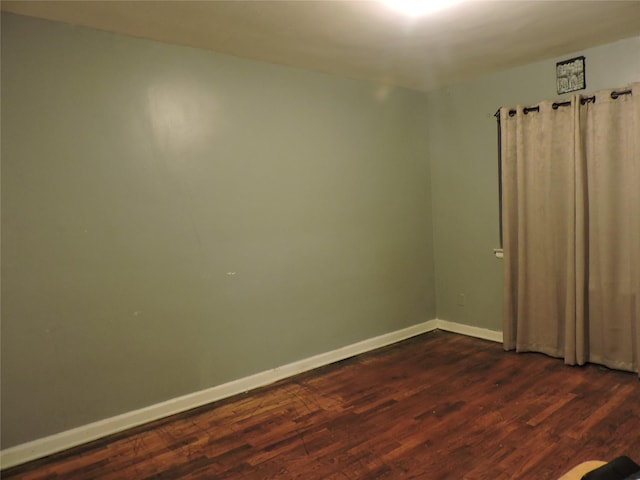 spare room featuring dark hardwood / wood-style flooring