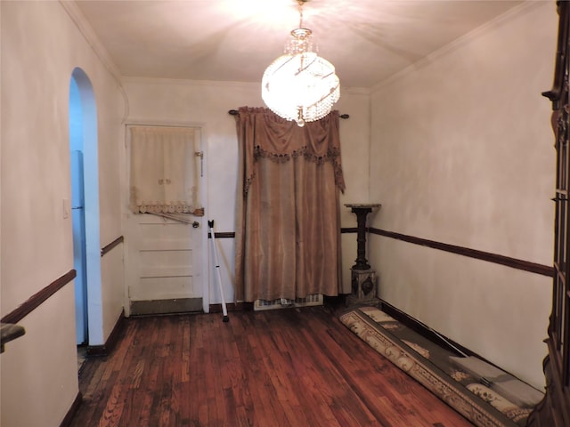 unfurnished dining area with dark hardwood / wood-style floors and crown molding