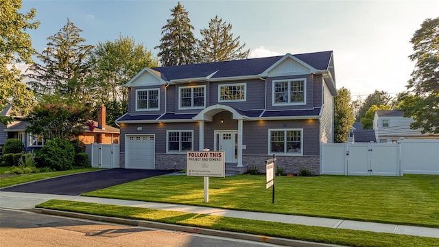 view of front of house with a garage and a front yard